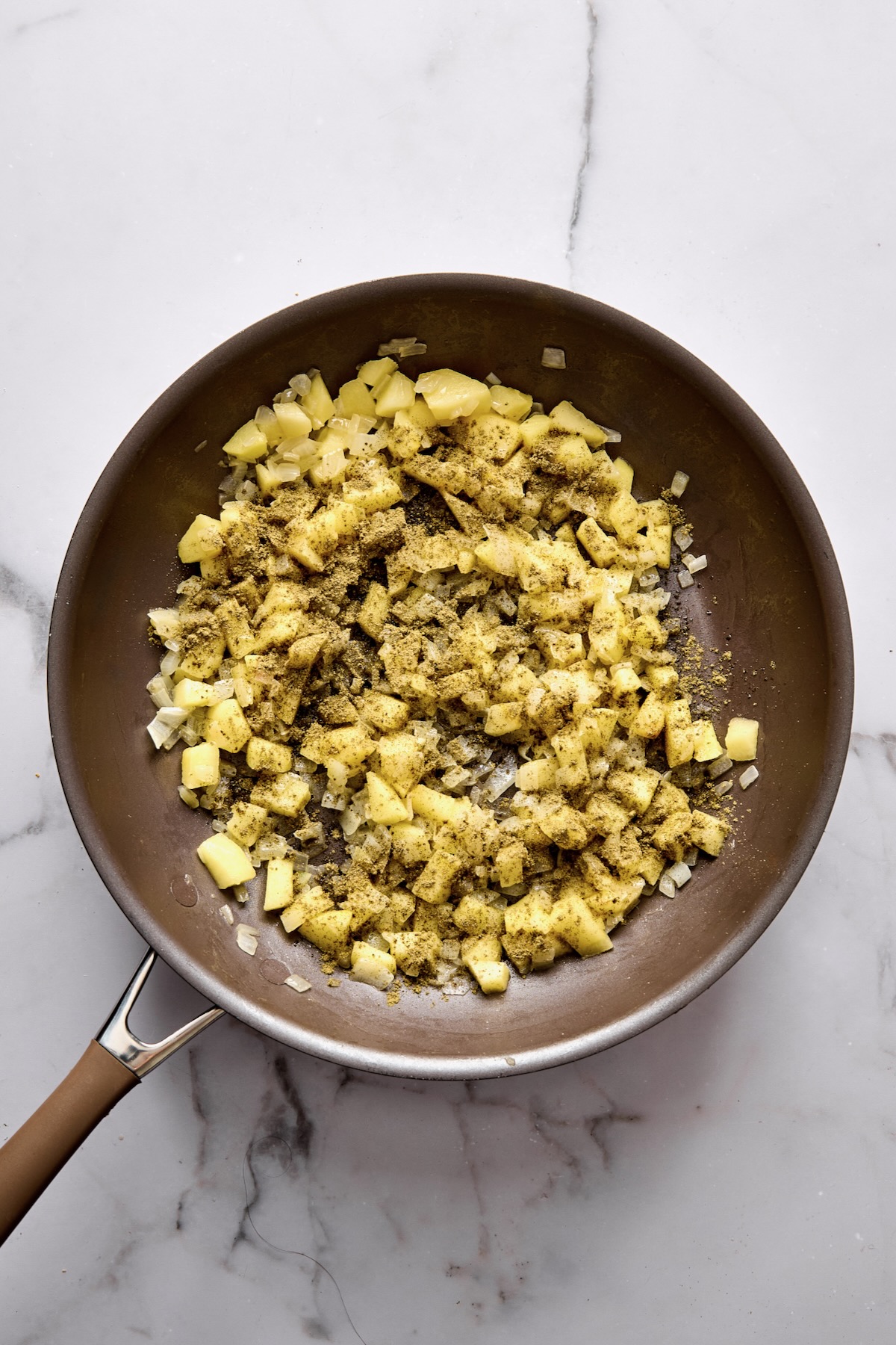 Cooked onions, apple and sage in nonstick skillet.