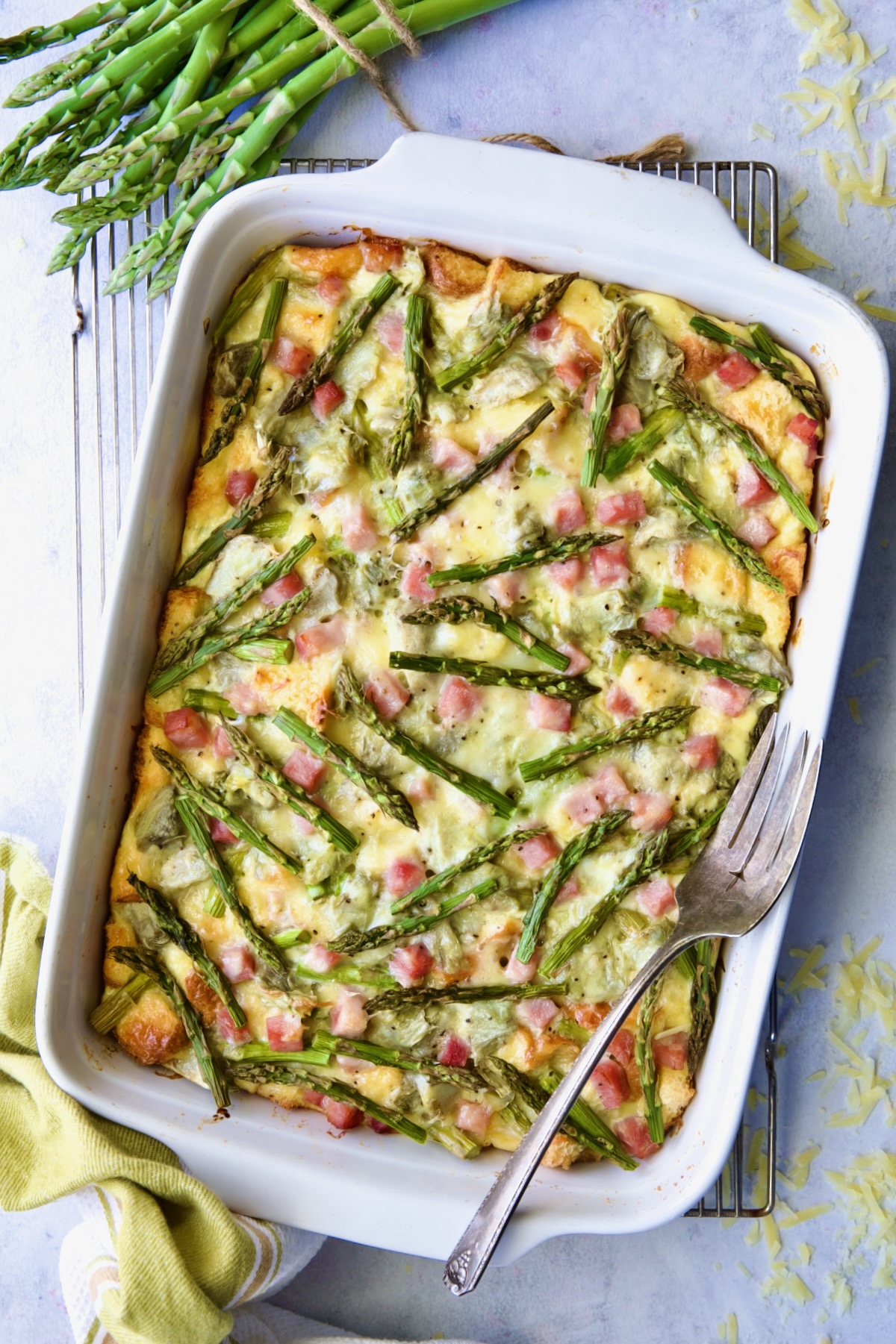 Baked Brioche Breakfast Strata on cooling rack with serving fork.