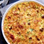 Uncut Crustless Quiche with Sausage Bacon and Ham in white quiche pan.