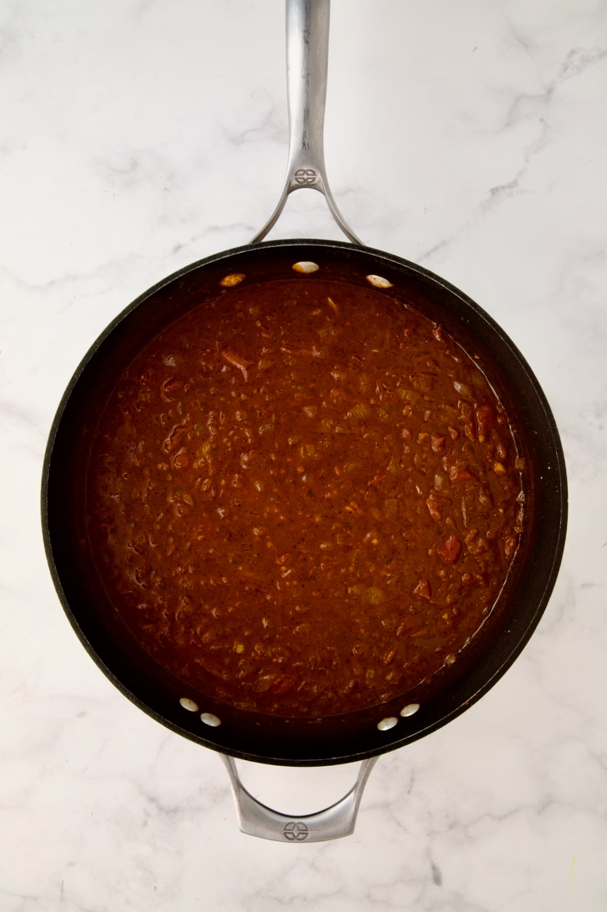 Cooked base for stew in nonstick skillet.