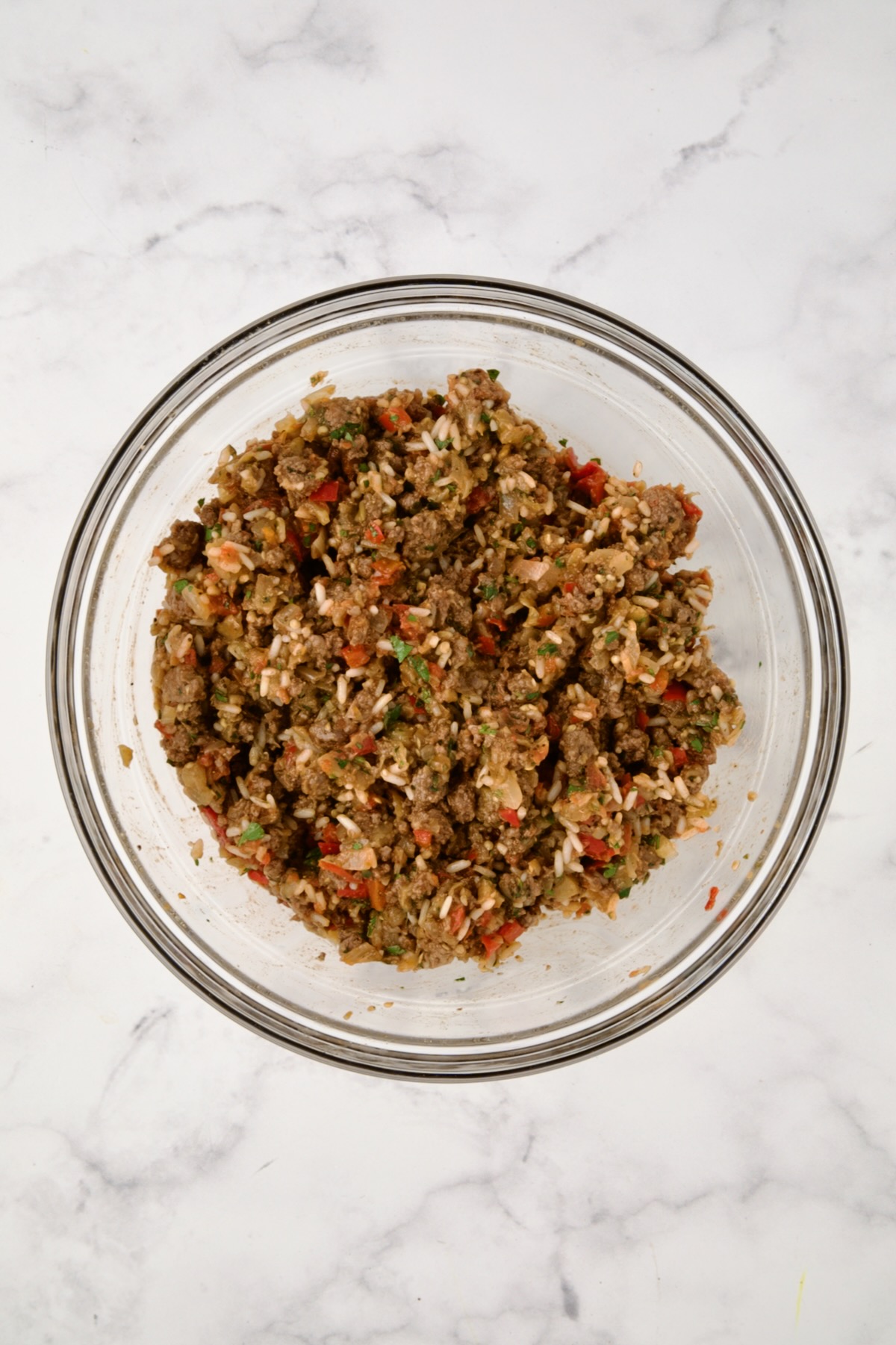 Filling for Stuffed Eggplant in glass bowl before after mixed together.
