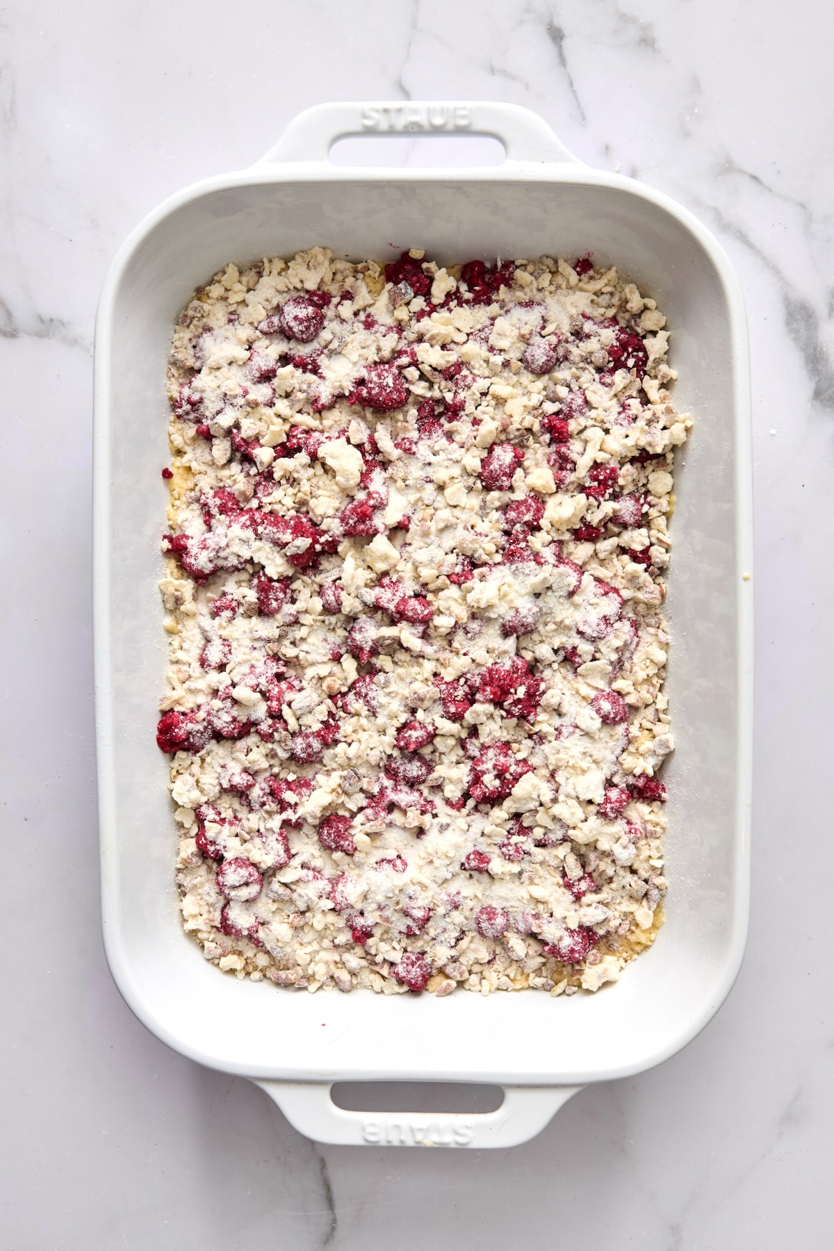 Coffee cake ready to bake in white rectangular baking dish.