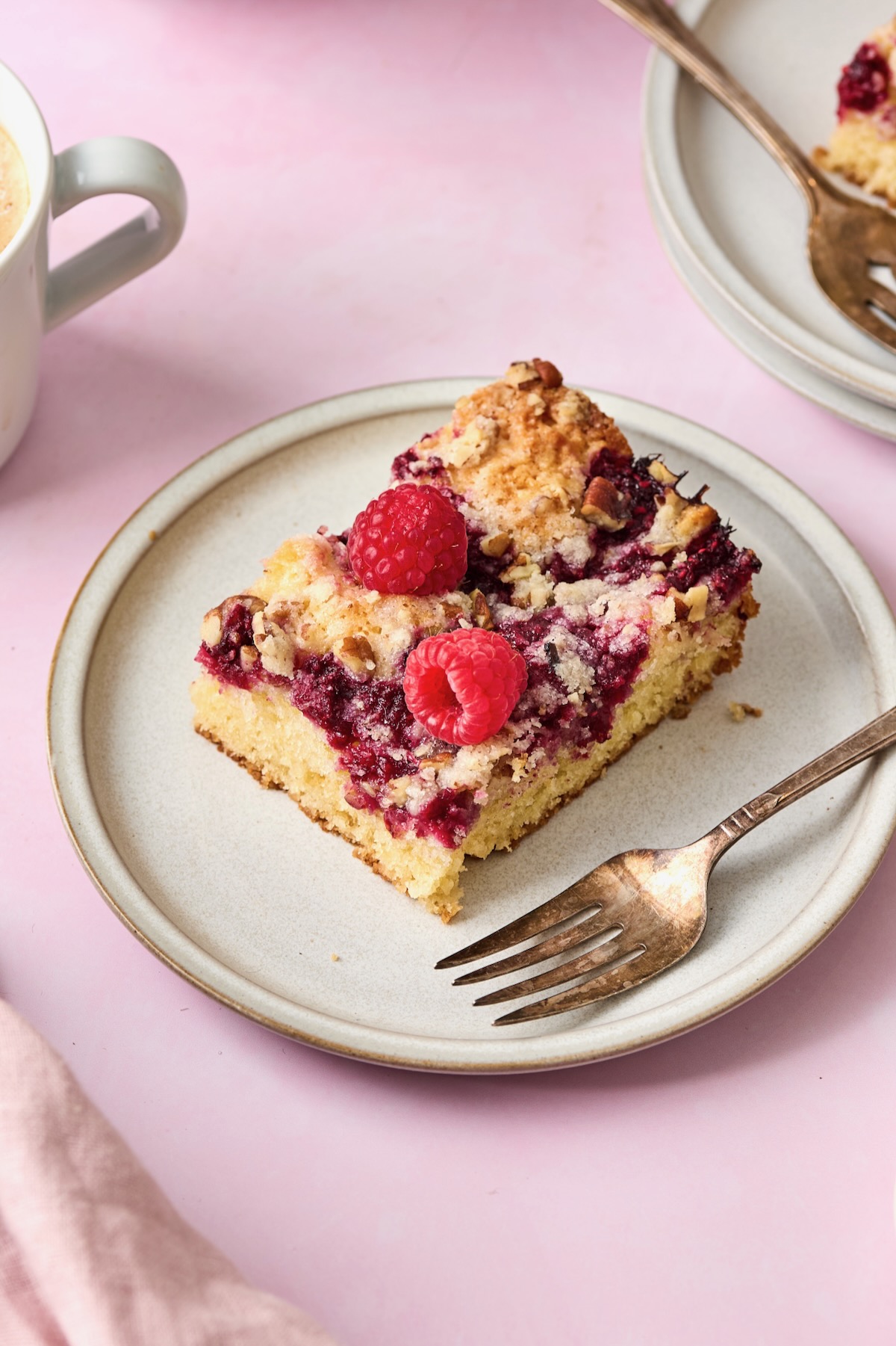 Piece of coffee cake on white plate with fork.
