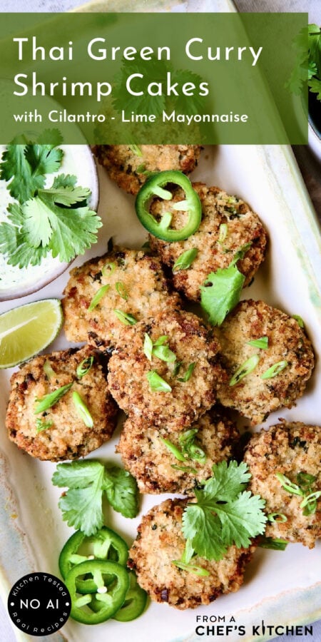 Thai Green Curry Shrimp Cakes on rectangular platter garnished with jalapeno slices, cilantro leaves and a lime wedge.