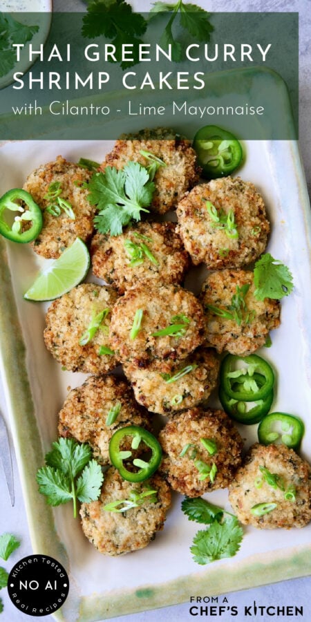 Thai Green Curry Shrimp Cakes on rectangular platter garnished with jalapeno slices, cilantro leaves and a lime wedge.