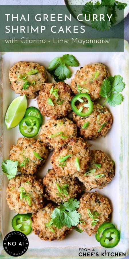Thai Green Curry Shrimp Cakes on rectangular platter garnished with jalapeno slices, cilantro leaves and a lime wedge.