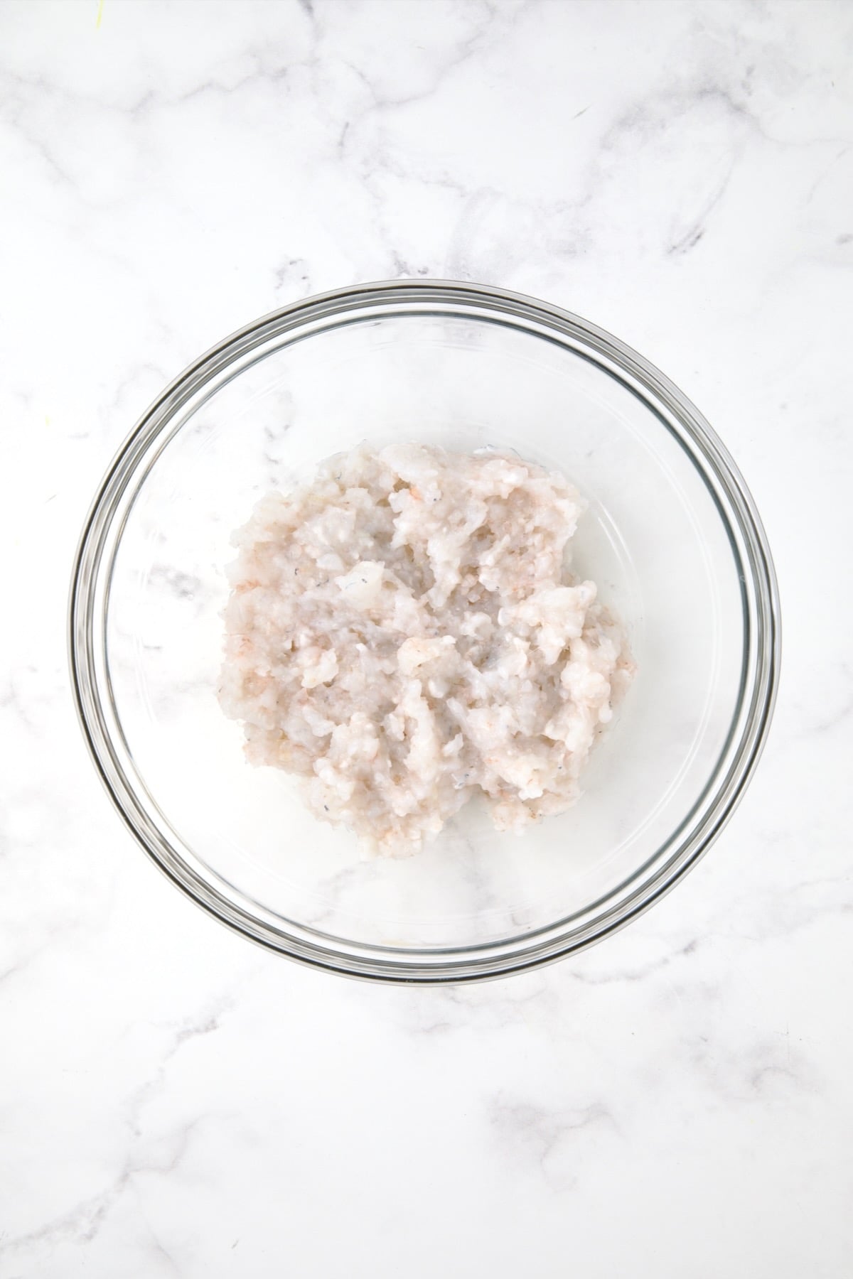 Chopped shrimp in glass bowl.