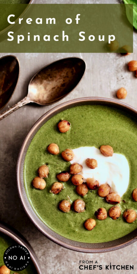 Pinterest graphic for Cream of Spinach Soup showing it in a brown bowl garnished with Greek yogurt and chickpeas.