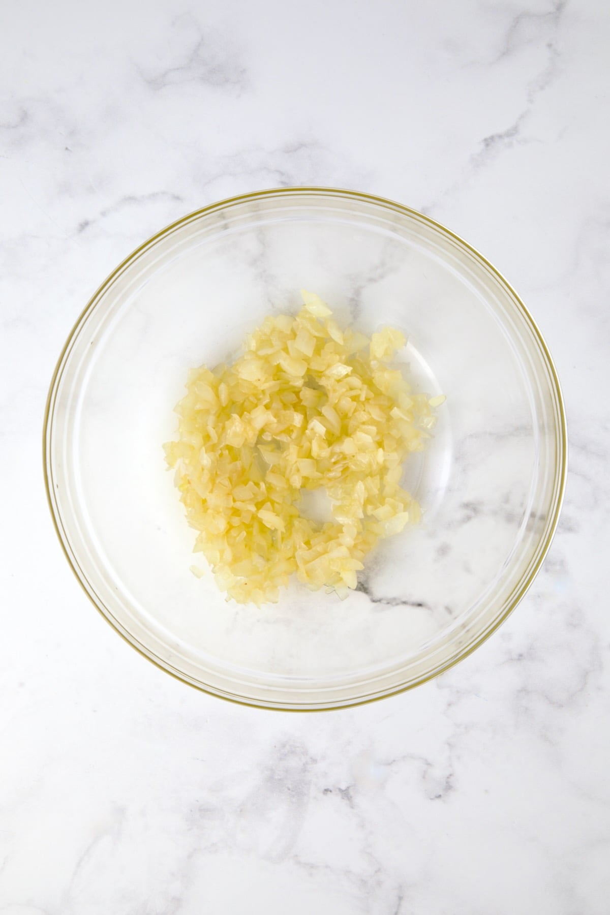 Cooked onions in glass bowl.