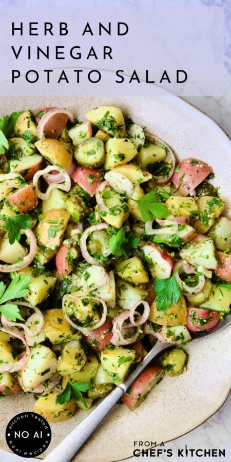 Pinterest graphic for Herb and Vinegar Potato Salad showing it in an earthenware bowl with serving spoon.