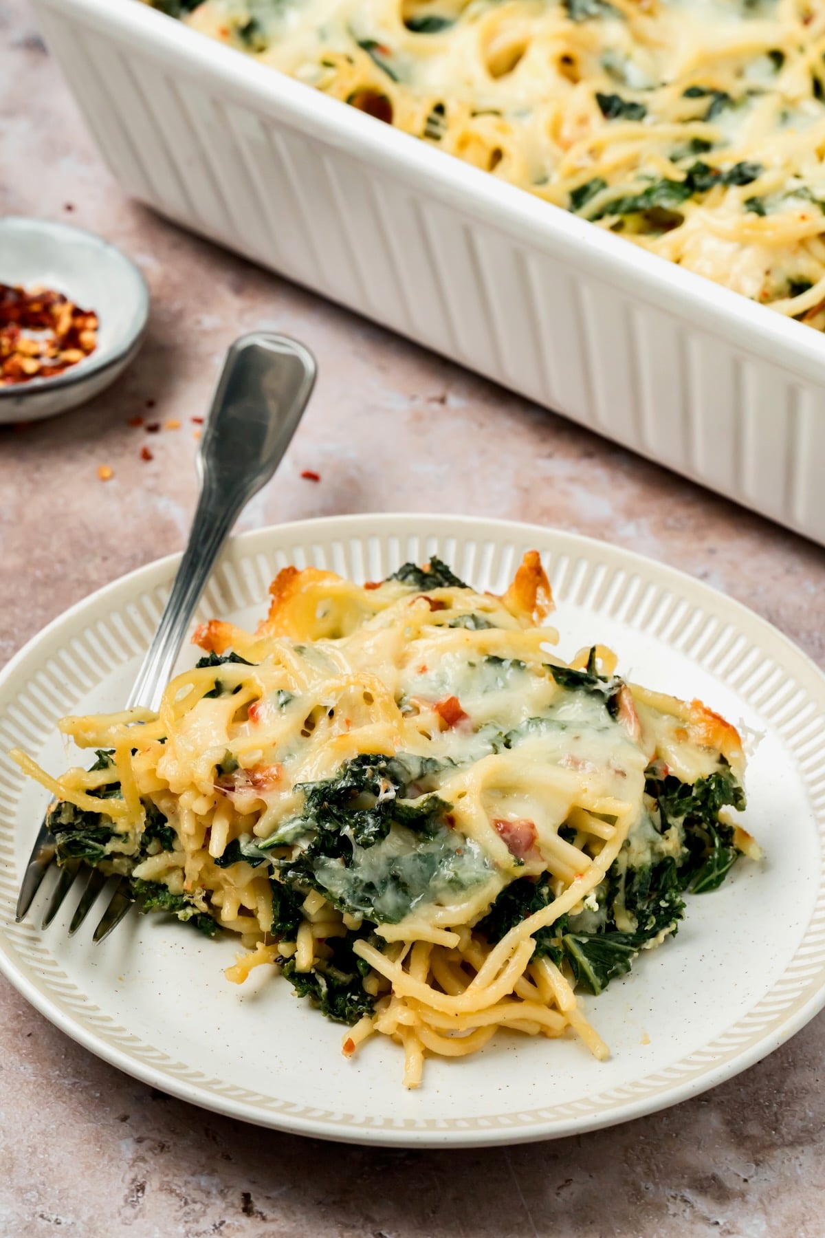 Piece of Pasta Frittata on a white plate.
