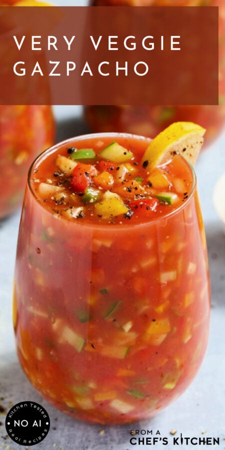 Pinterest graphic for Very Veggie Gazpacho showing it in a glass with lemon wedge sprinkled with freshly ground black pepper.