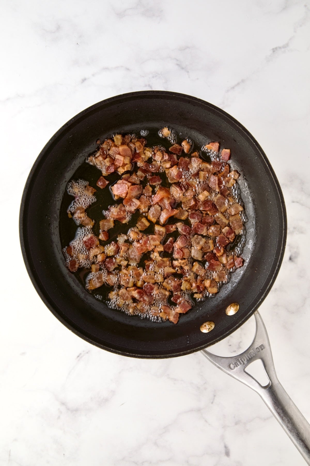 Cooked, crispy bacon in nonstick skillet.