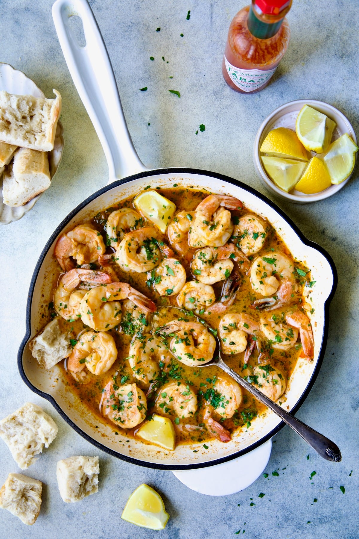 Cajun Butter Shrimp in white enamel cast iron skillet.