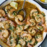 Cajun Butter Shrimp in white enamel cast iron skillet.