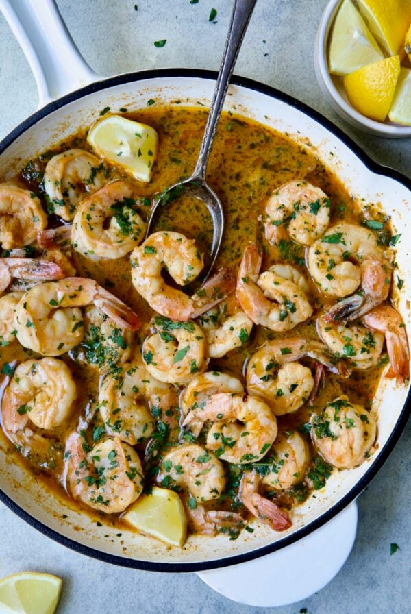 Cajun Butter Shrimp in white enamel cast iron skillet.