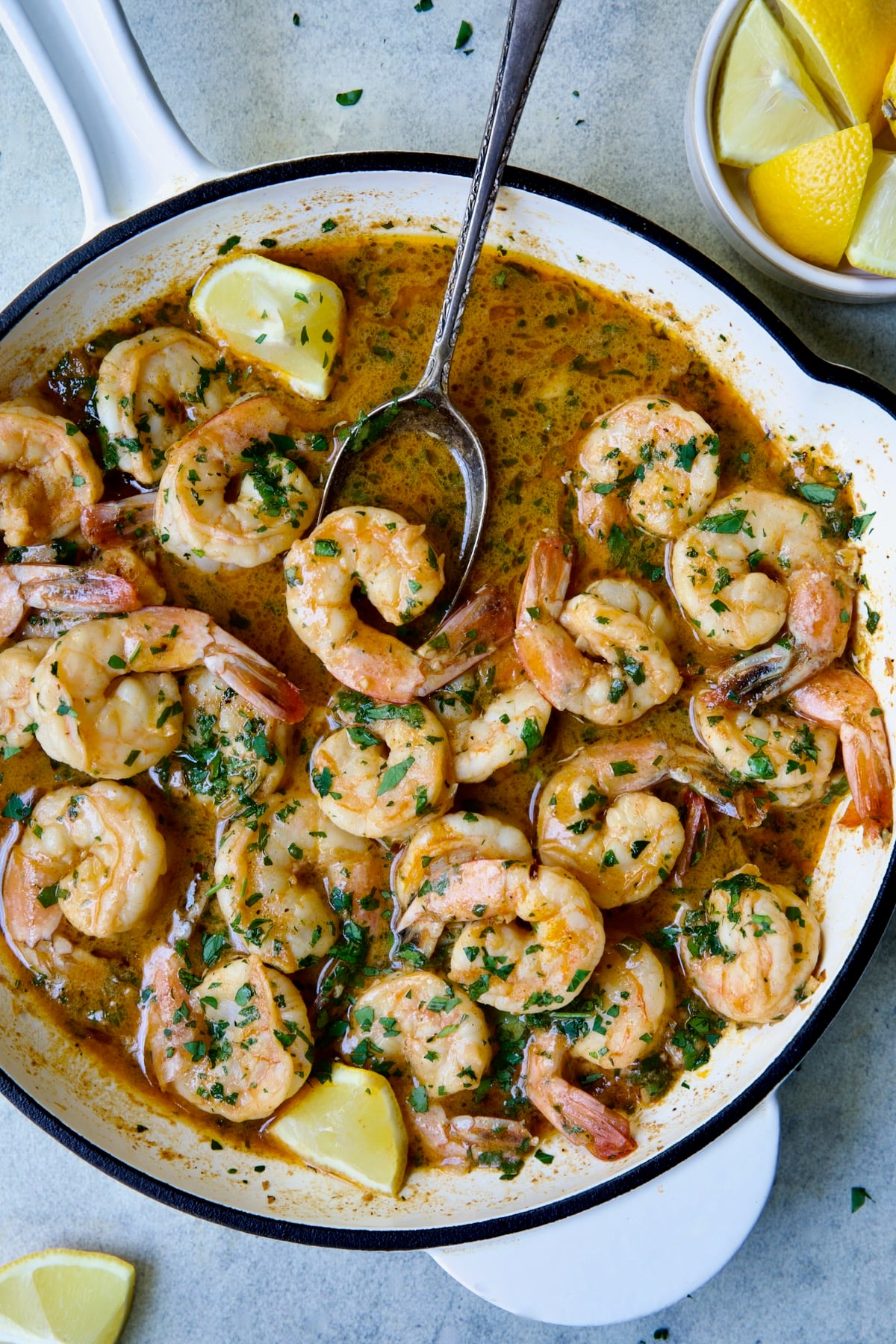 Cajun Butter Shrimp in white enamel cast iron skillet.