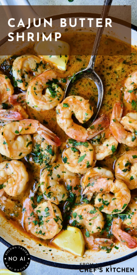Pinterest graphic for Cajun Butter Shrimp showing it in a white nonstick skillet with spoon scooping up one shrimp.
