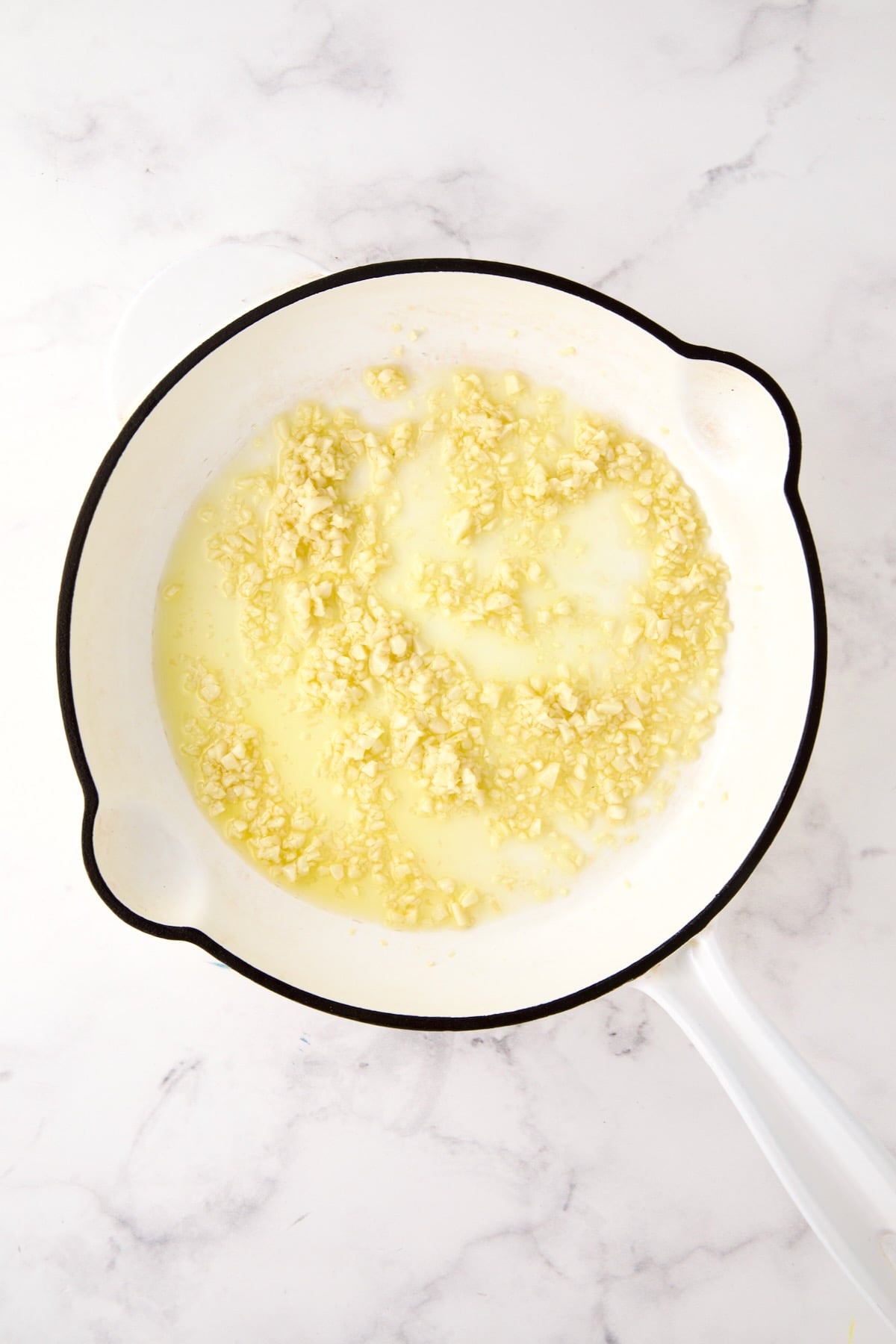 Softened garlic in olive oil in white enamel cast iron skillet.
