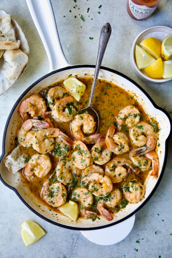 Cajun Butter Shrimp in white enamel cast iron skillet.
