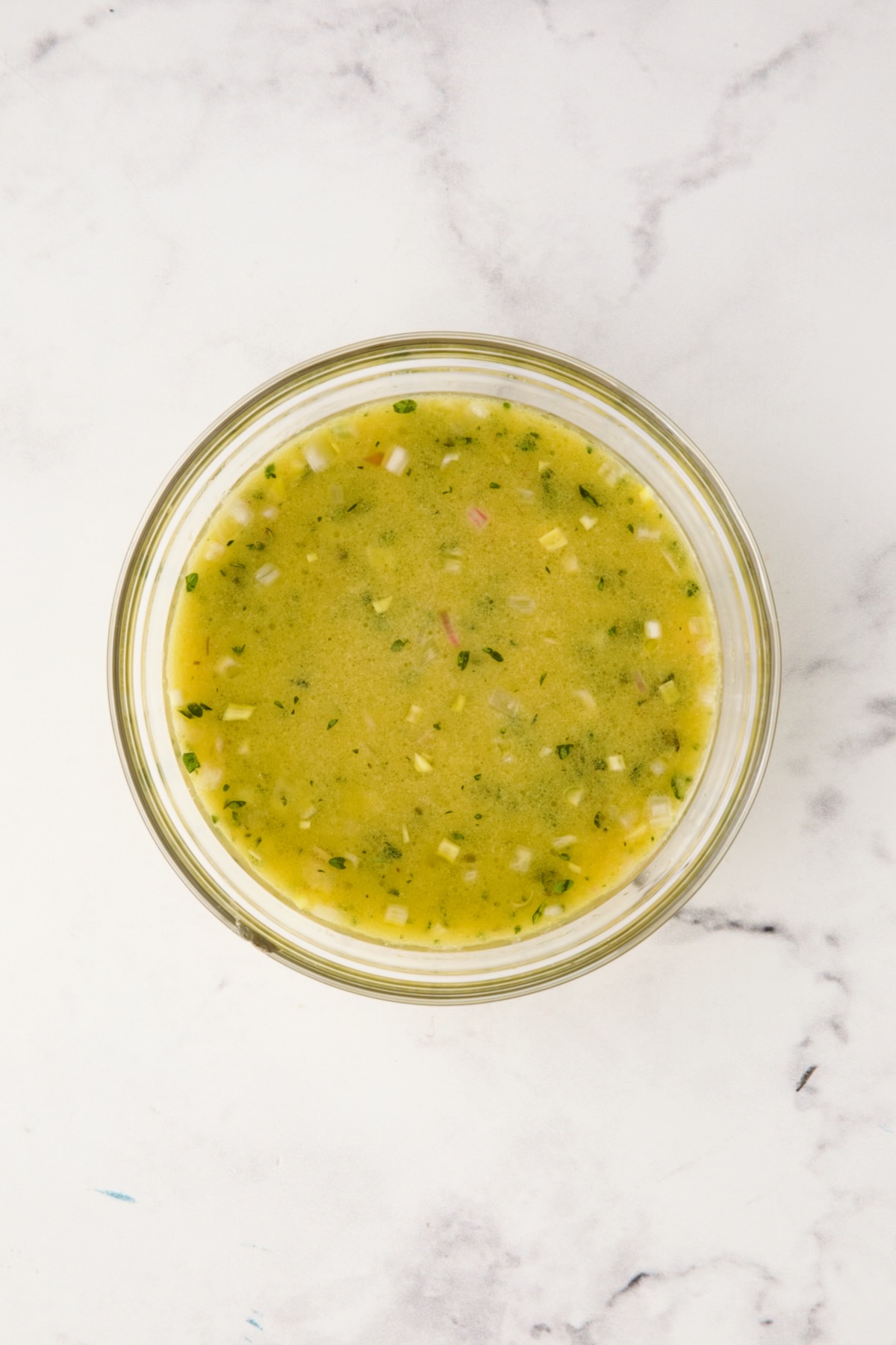 Salad dressing in glass bowl.