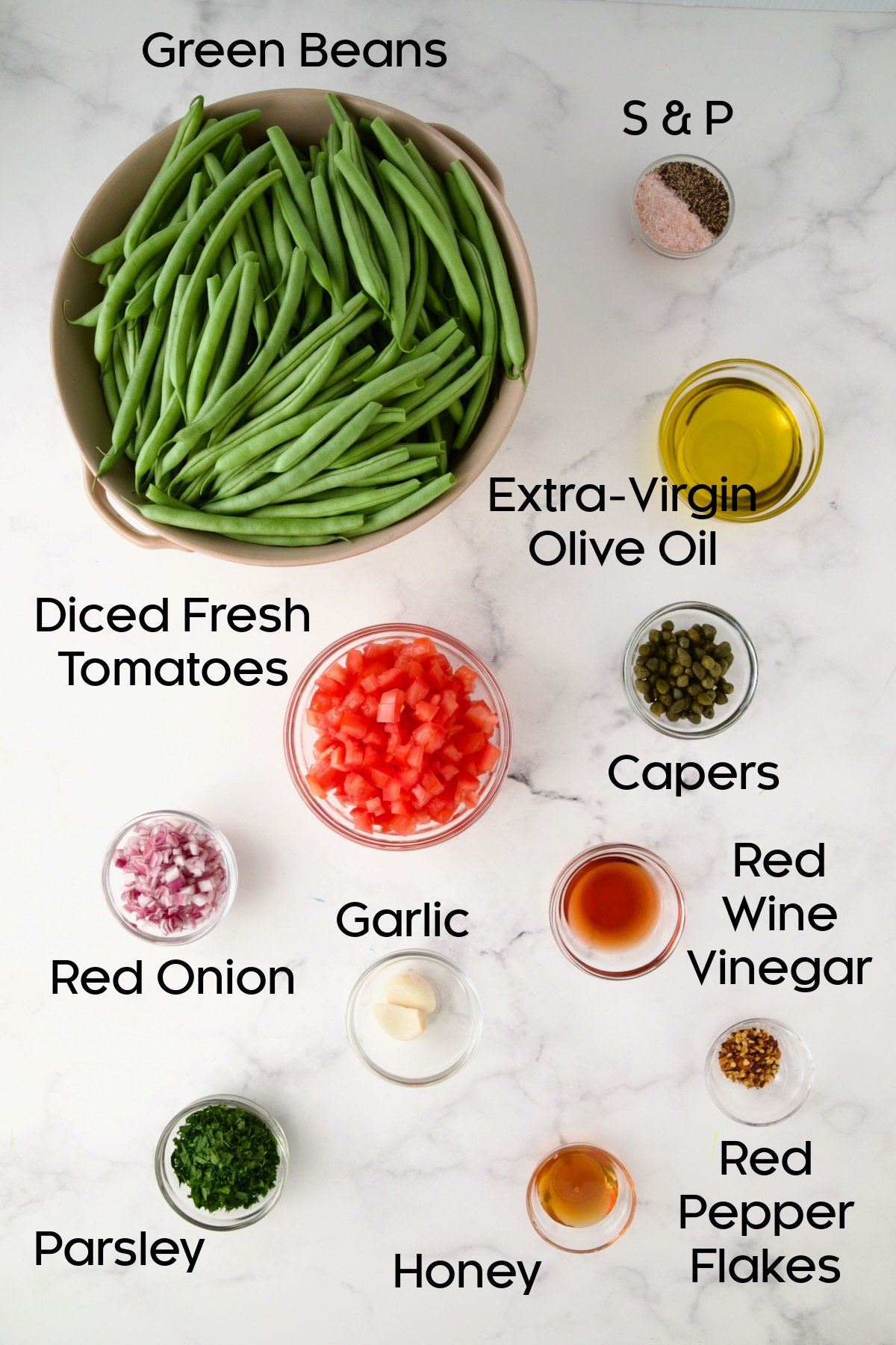 Ingredients for Roasted Green Beans with Tomato Caper Relish in glass bowls.