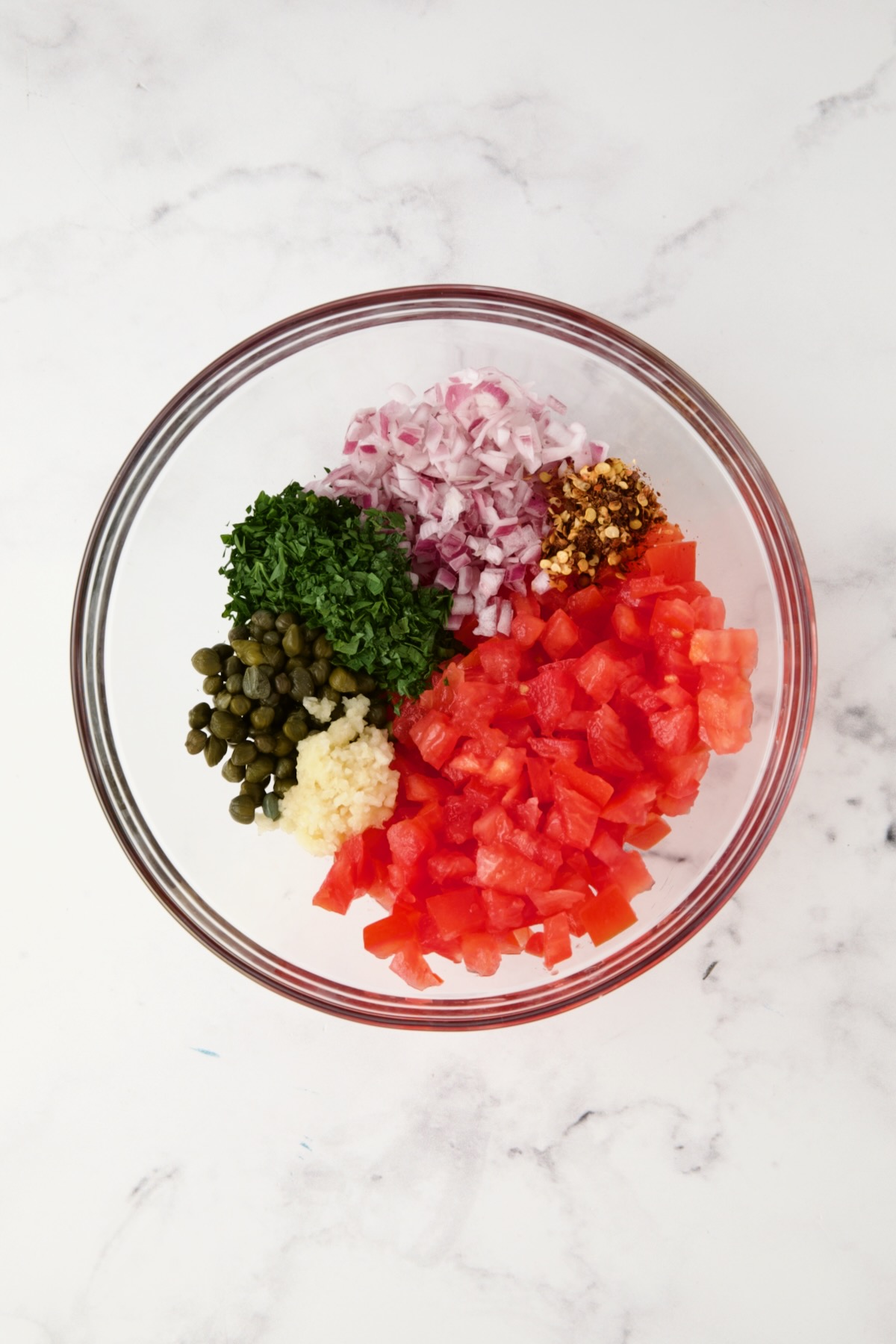 Ingredients for relish in glass bowl before being combined.