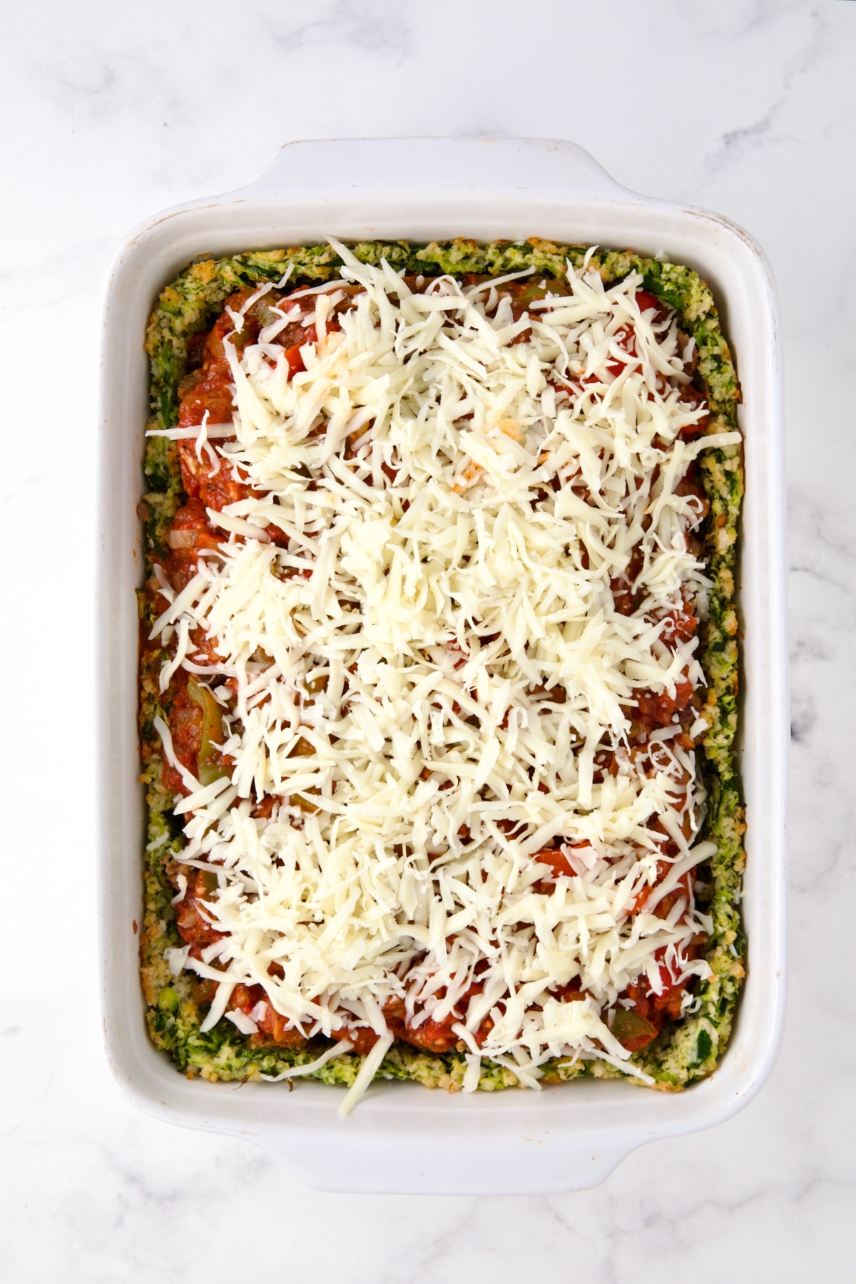 Cheese sprinkled over the top of the Zucchini Pizza Casserole before being baked.