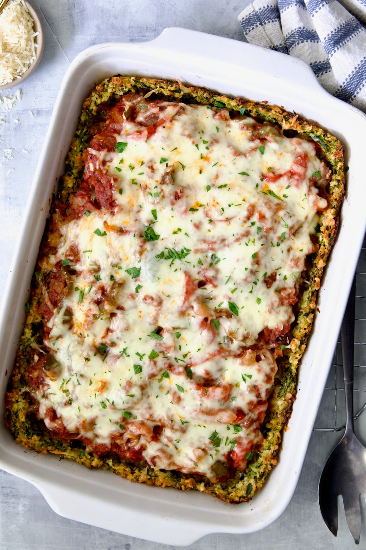 Zucchini Pizza Casserole in white rectangular baking dish after being baked.
