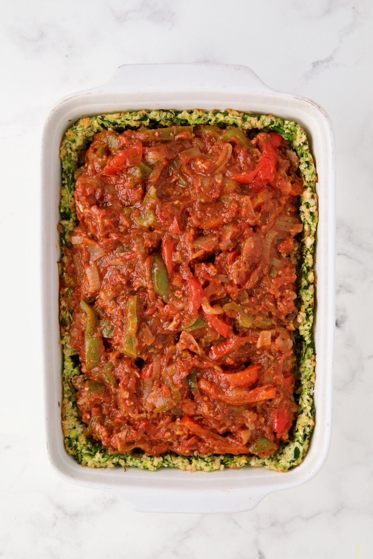 Tomato pepper sauce over sausage.
