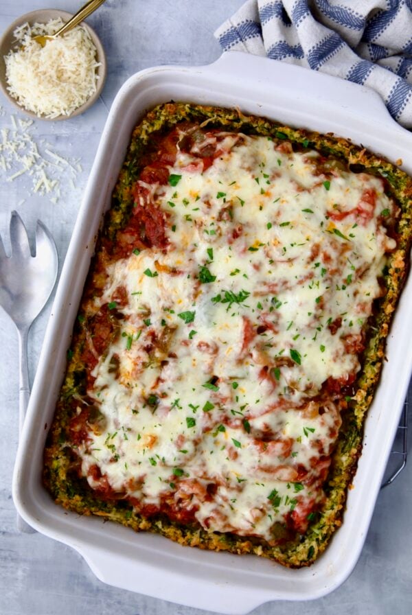 Zucchini Pizza Casserole in white rectangular baking dish before being cut.