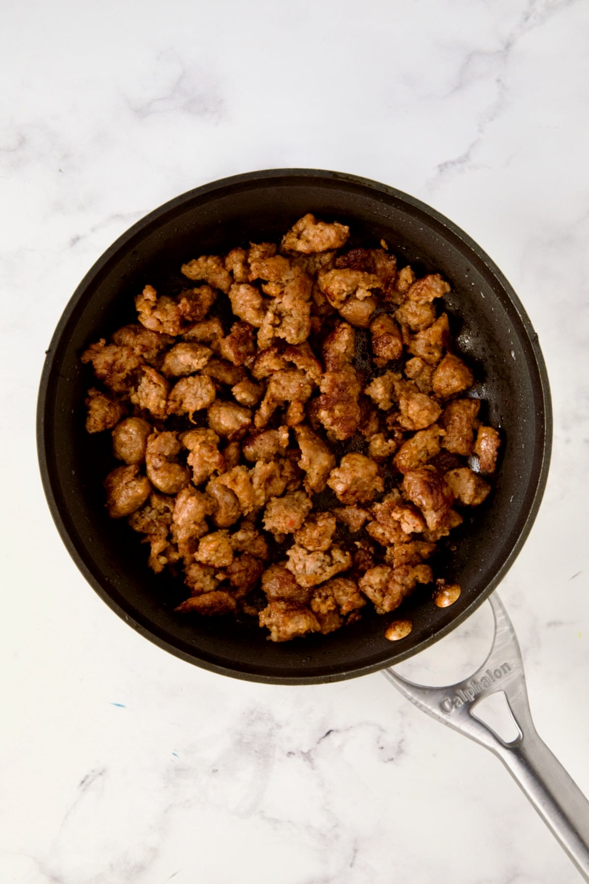 Cooked Italian sausage in nonstick skillet.