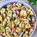 Antipasto Tortellini Salad in serving bowl with serving spoon.
