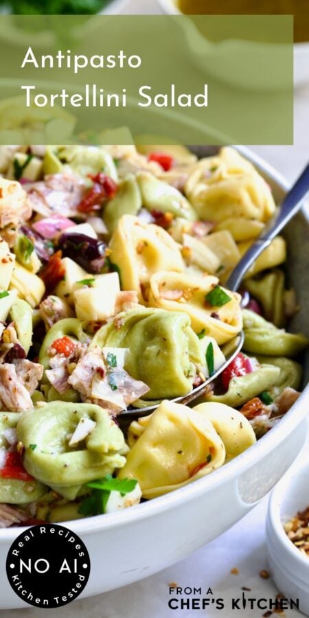Pinterest graphic for Antipasto Tortellini Salad showing a serving spoon scooping some from a serving bowl.
