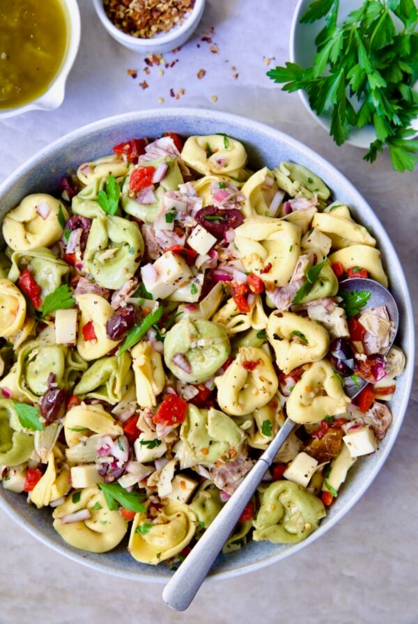 Antipasto Tortellini Salad in serving bowl with serving spoon.