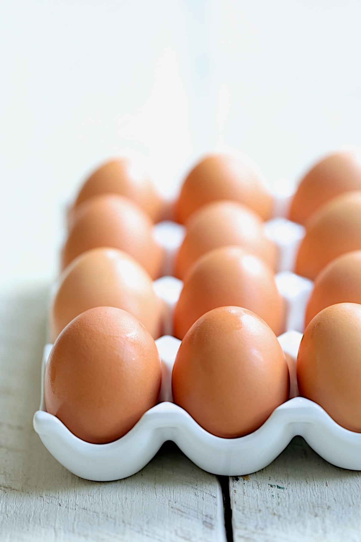 Brown eggs in white egg holder.