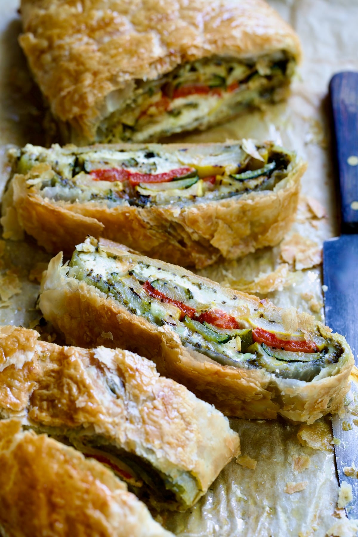 Sliced Italian Vegetable Strudel on parchment paper.