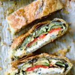 Sliced Italian Vegetable Strudel on parchment paper.