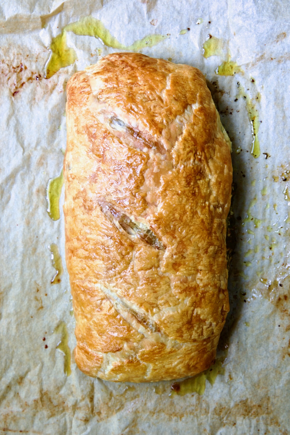 Fully baked Italian Vegetable Strudel on parchment paper.