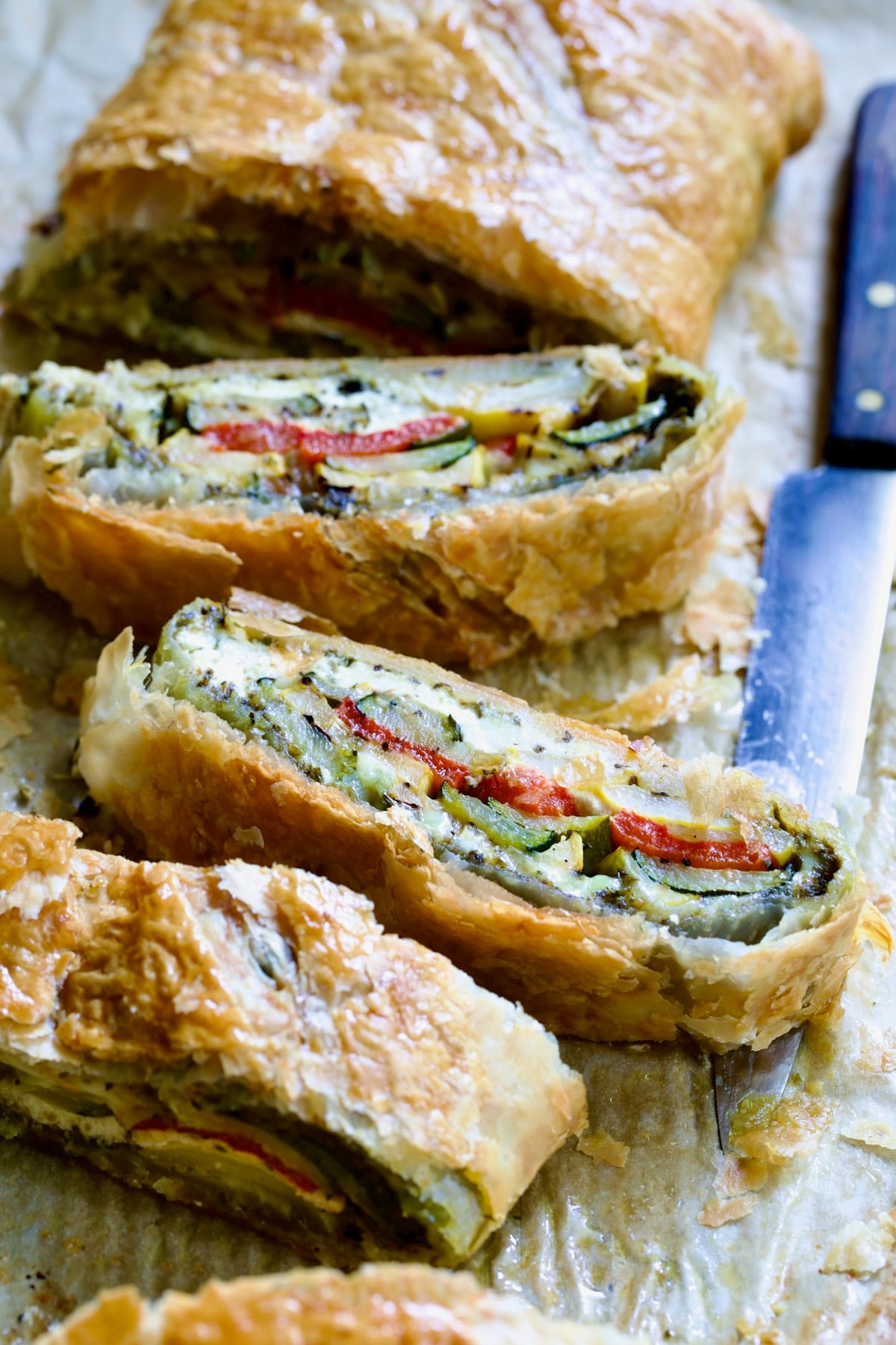 Sliced Italian Vegetable Strudel on parchment paper.