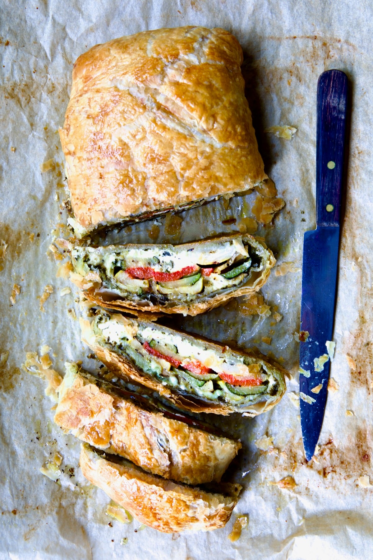 Sliced Italian Vegetable Strudel on parchment paper.