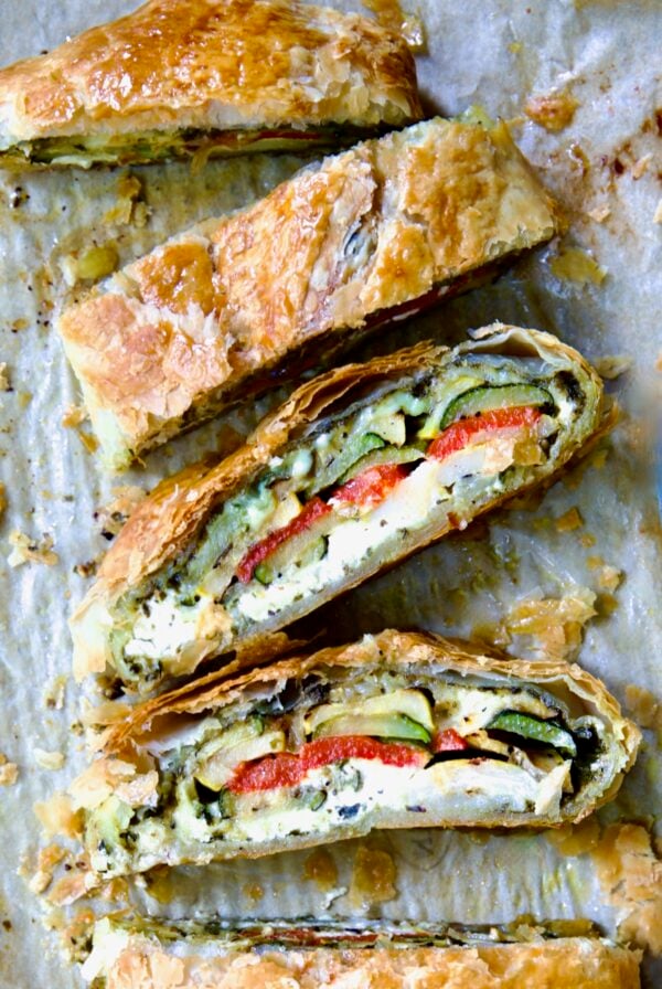 Sliced Italian Vegetable Strudel on parchment paper.