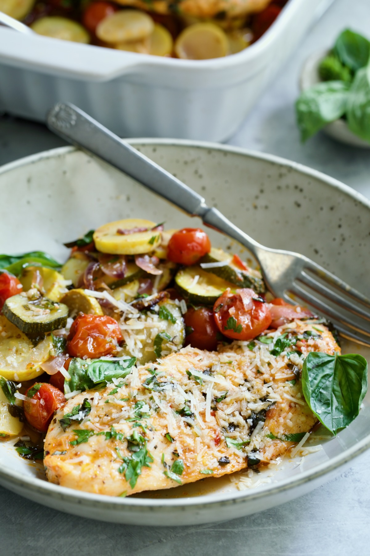 One serving of One-Pan Summer Vegetable and Chicken Bake in a bowl.