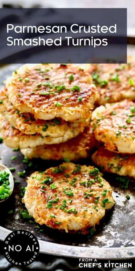 Pinterest graphic for Parmesan Crusted Smashed Turnips showing them on a metal tray garnished with chopped chives.