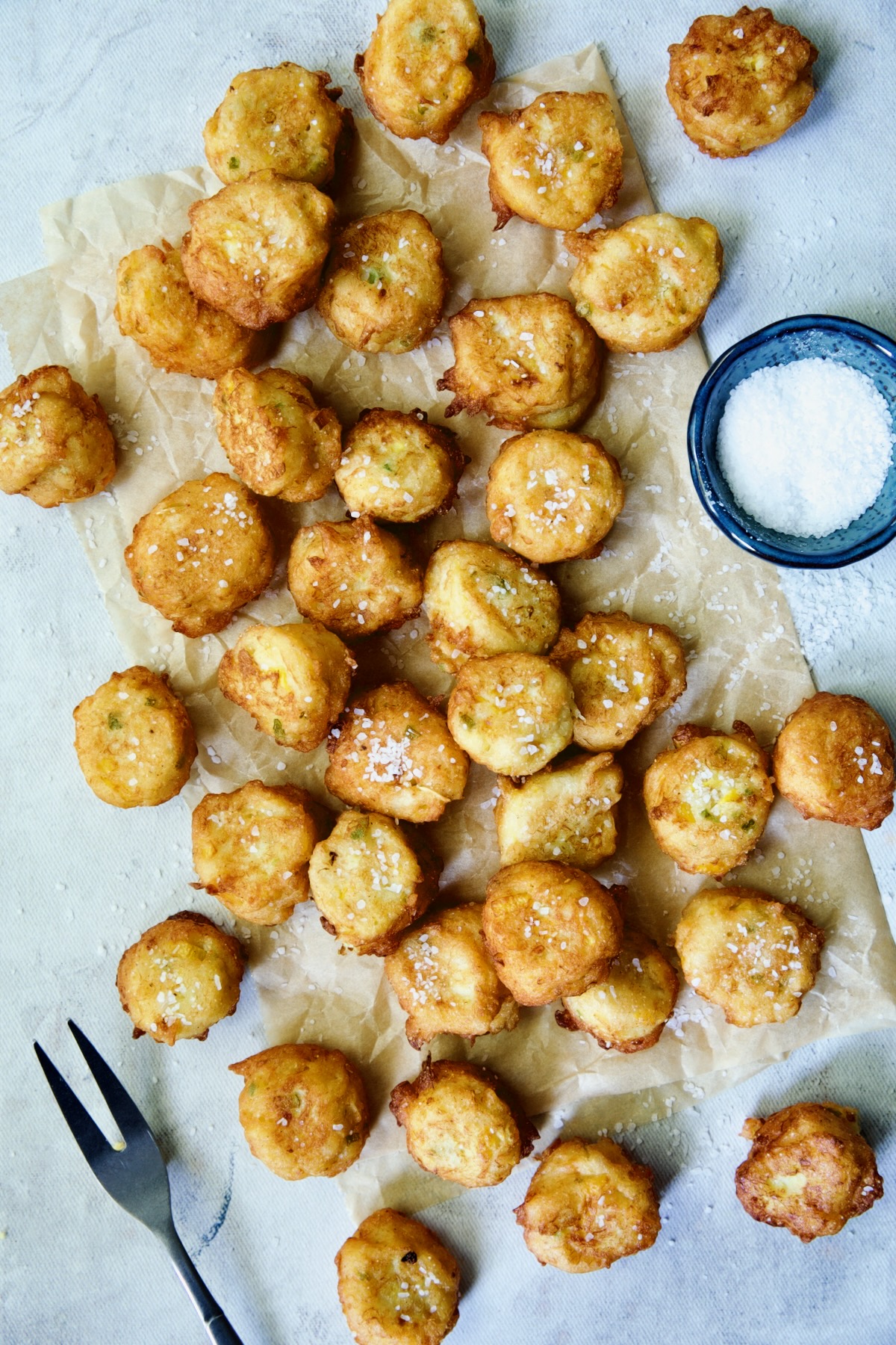 Fried squash puppies on parchment paper.