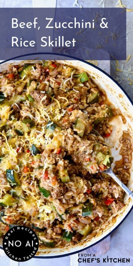 Pinterest graphic for Beef, Zucchini and Rice Skillet showing it in a white enamel cast iron skillet with serving spoon scooping some up.