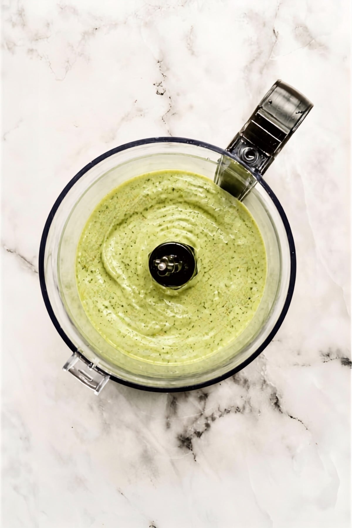 Completed avocado salad dressing in food processor.