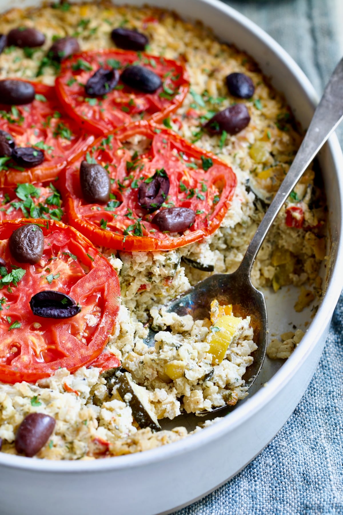 Greek Vegetable Casserole Recipe in oval baking dish with serving spoon.