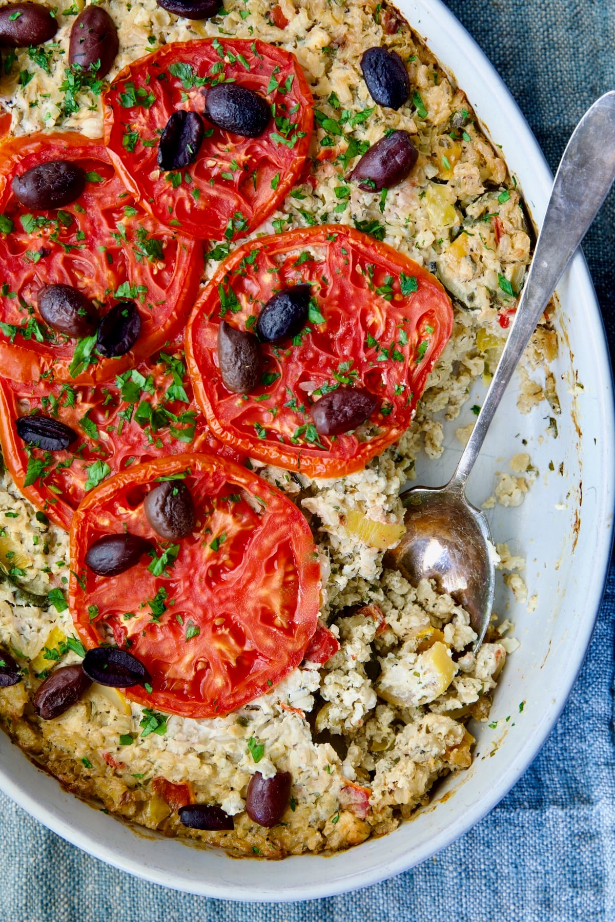 Greek Vegetable Casserole Recipe in oval baking dish with serving spoon.