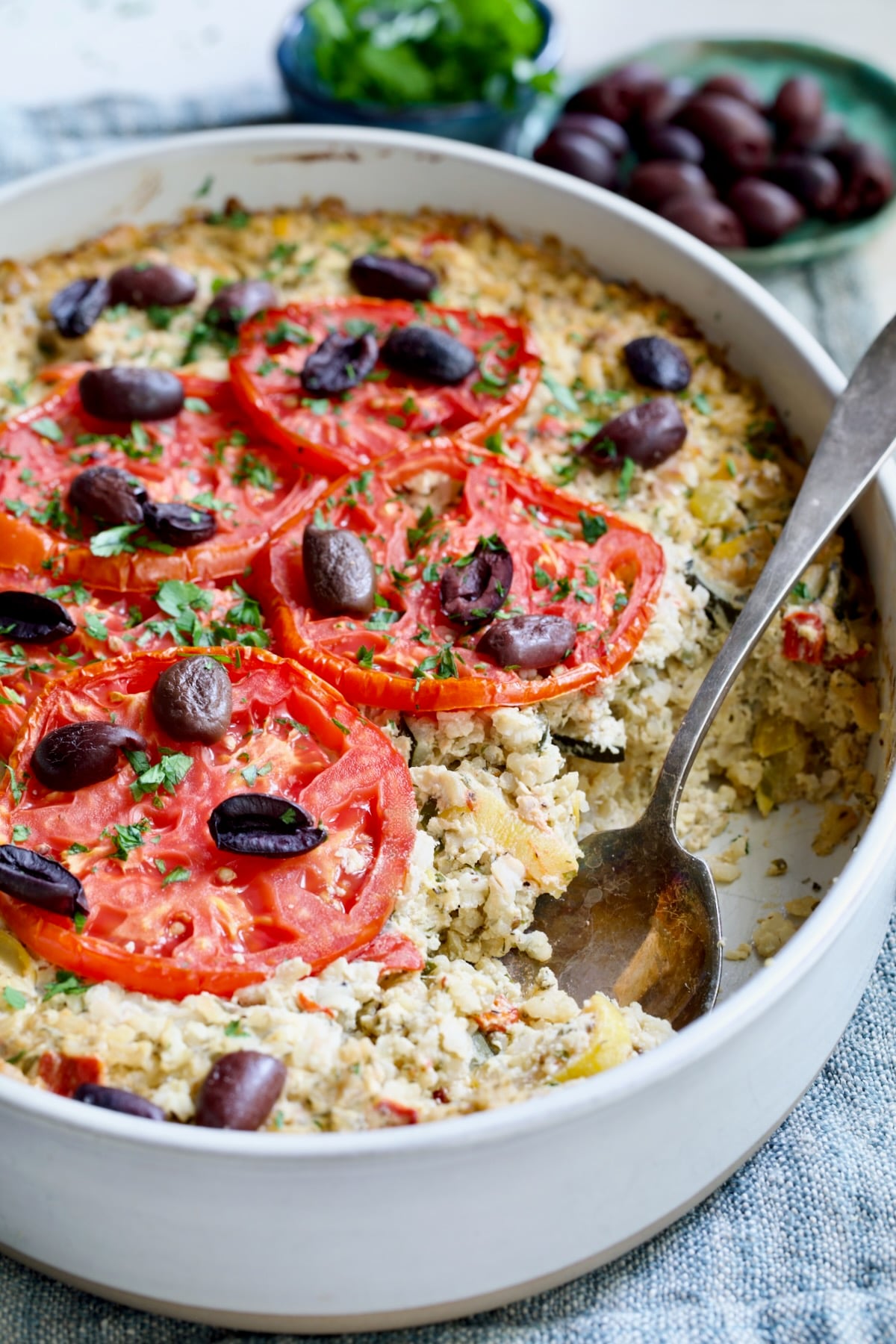 Greek Vegetable Casserole Recipe in oval baking dish with serving spoon.